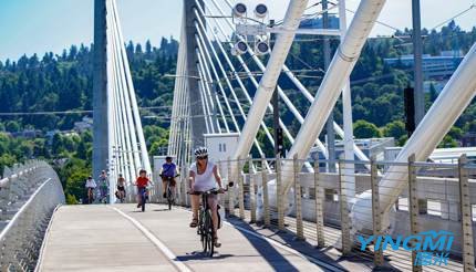 People cycling on Tilikum Bridge, Portland, Oregon